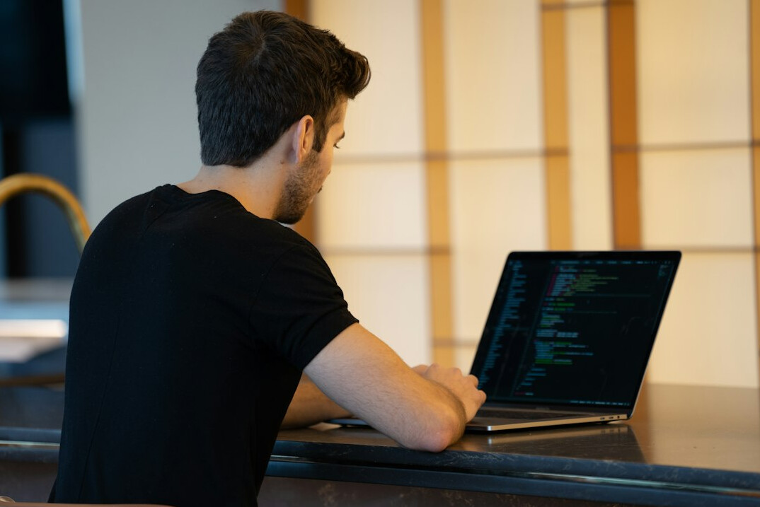 person learning to code on laptop